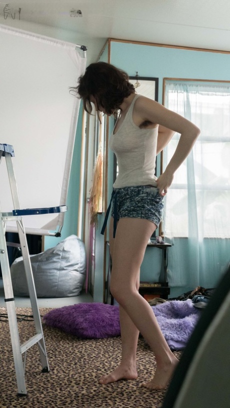 Slender Charlee shows nice breasts and thick underarm hair while getting dressed