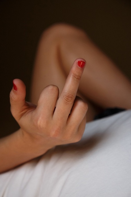 Authentic young adult with tiny breasts Leah Gotti exposes her attractive body in a hotel room