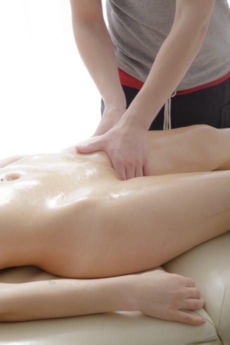 Alluring young adult with nice breasts and curves gets lubed up before anal intimacy with masseur