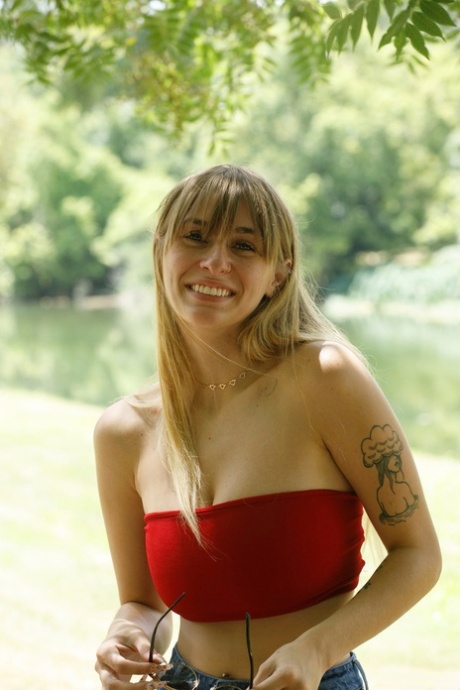 Charming babe in booty shorts Angel Youngs shows off her juicy breasts outdoors