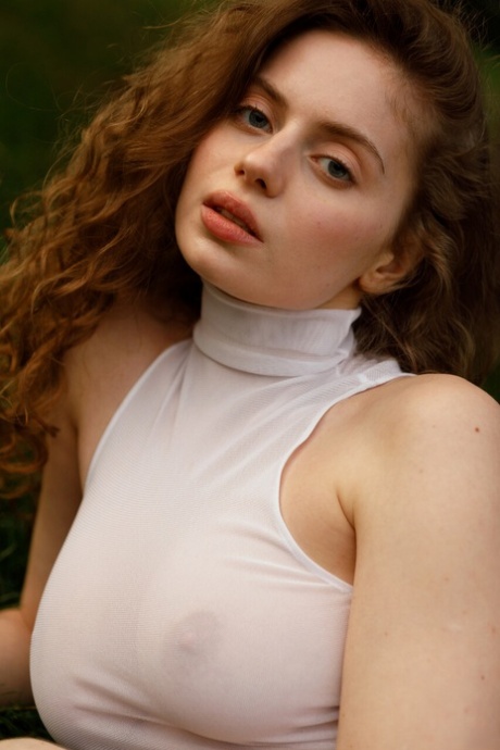 Beautiful braless authentic babe with big breasts posing in her white dress outside