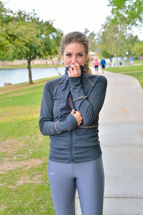 Cute jogger Reese undresses and shows her tiny breasts and flexibility outdoors