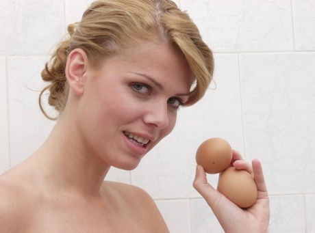 Solo girl Katalin Kiraly cracks an egg while taking a shower