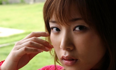 Young Japanese girl exposes her firm breasts and trimmed bush