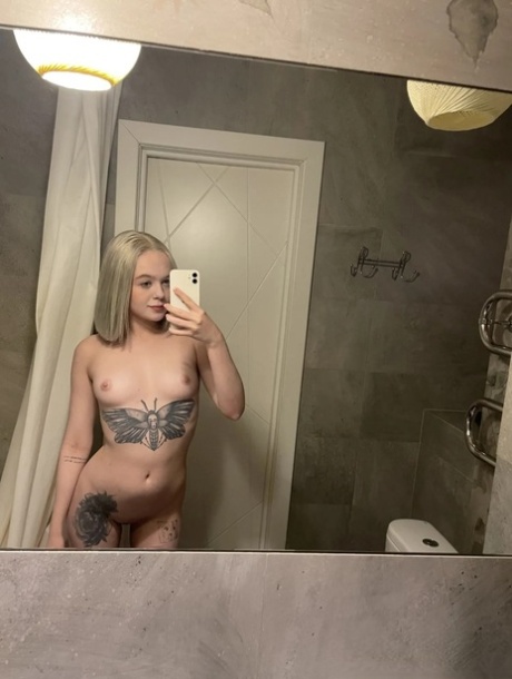 Blonde young adult takes nudes showing her small breasts & her butterfly tattoo