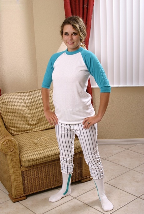 Blonde college girl Traci displaying smiley face while stripping down to socks