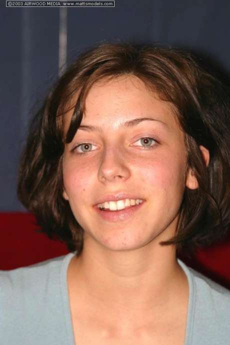 Young brunette model Nico uncovers her pert breasts before parting femininity lips