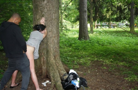 Slutty brunette gets picked up and fucked outdoor by two well-hung guys