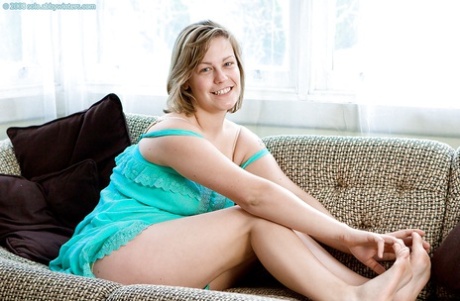 Busty blonde Augustine poses in lingerie before spreading hairy cooter