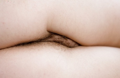 Busty blonde Augustine poses in lingerie before spreading hairy cooter