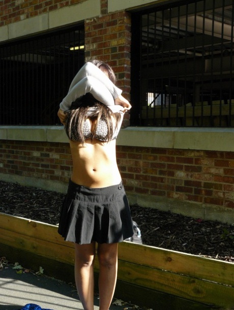 Ebony chick fingers her femininity on roadway while a jogger passes by