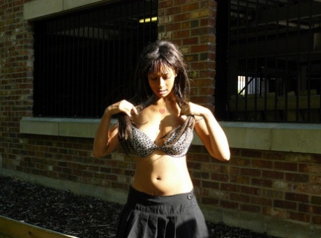 Ebony chick fingers her femininity on roadway while a jogger passes by