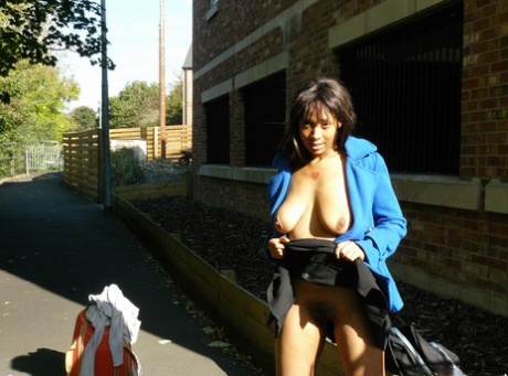 Ebony chick fingers her femininity on roadway while a jogger passes by