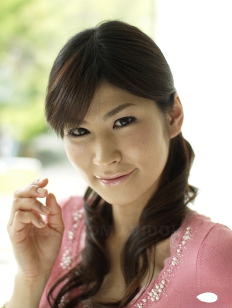 Clothed Japanese model Yuka Yamada shows her bare legs in a skirt