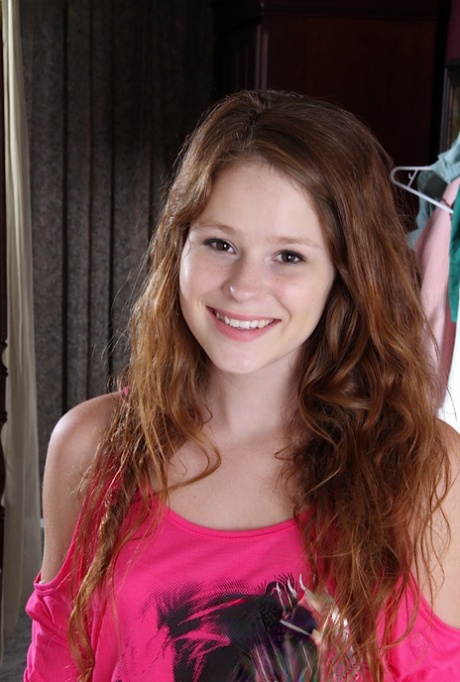 Young first timer Alice Rae folds back the labia lips of her bald femininity