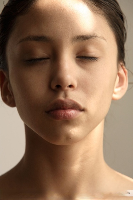 Thin young adult Alexis thrusts her perky breasts forth in front of a mirror