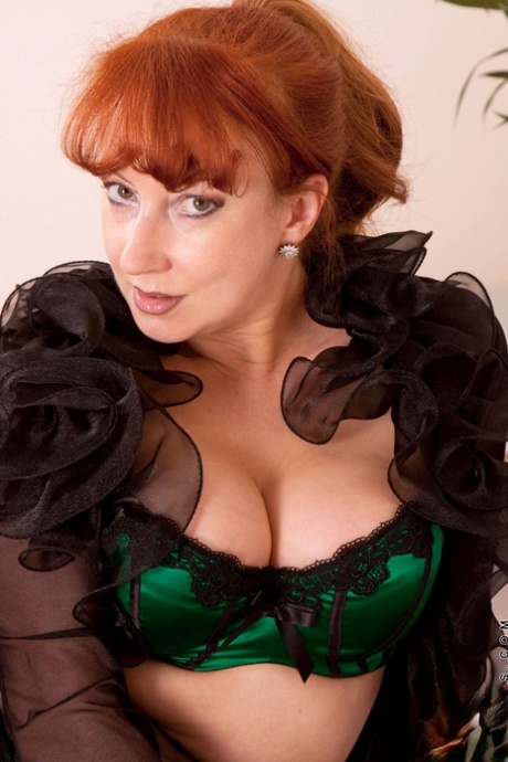 Mature seductress Red posing and masturbating in her alluring lingerie