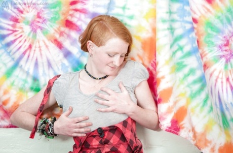 Redhead punk chick Isadora fondles all natural breasts and fingers hairy twat