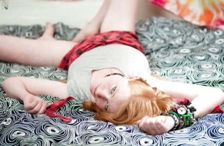 Redhead punk chick Isadora fondles all natural breasts and fingers hairy twat