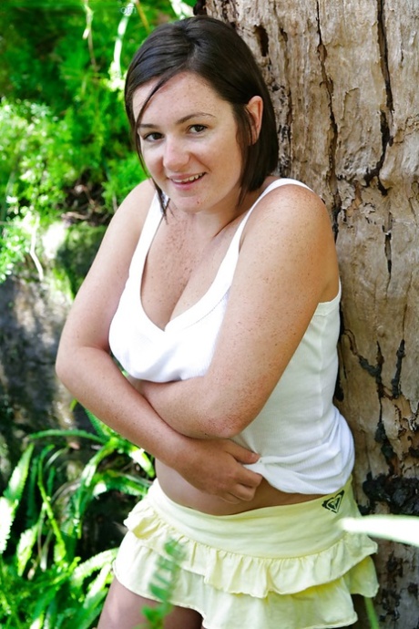 Chubby girl with freckles and big natural breasts spreads hairy cunt outside