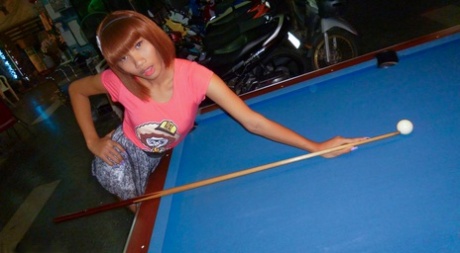 Red-haired Asian ladyboy lifts dress up to flash manhood in public place