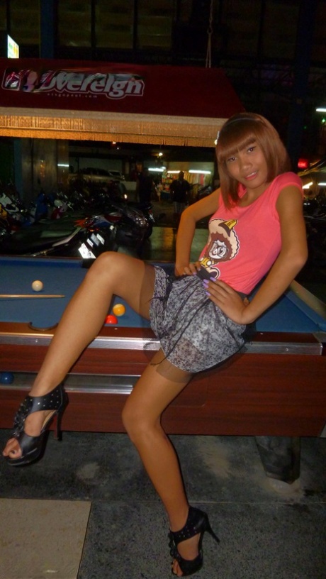 Red-haired Asian ladyboy lifts dress up to flash manhood in public place