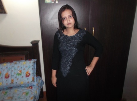 Attractive Indian model in tight jeans posing seductively in alluring lace bra