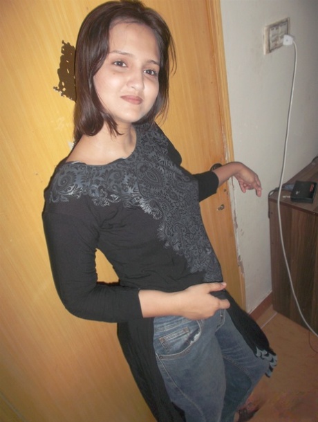 Attractive Indian model in tight jeans posing seductively in alluring lace bra