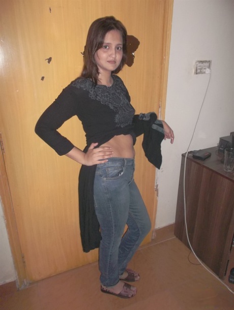 Attractive Indian model in tight jeans posing seductively in alluring lace bra