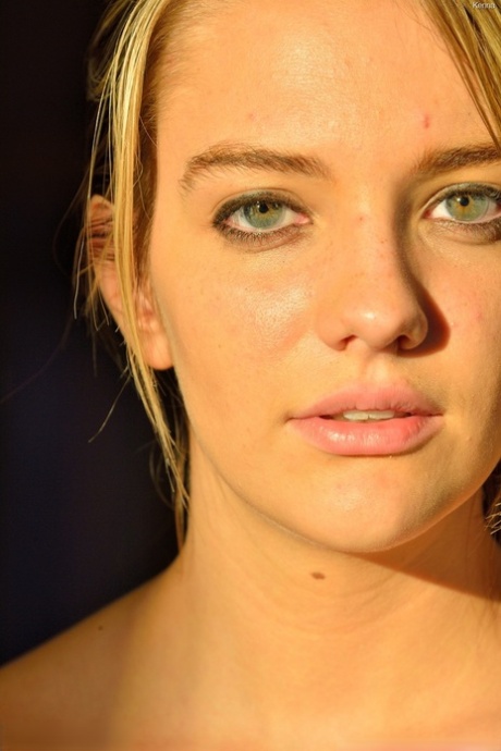 Blonde natural young adult spreading her shaved femininity wide for closeup view