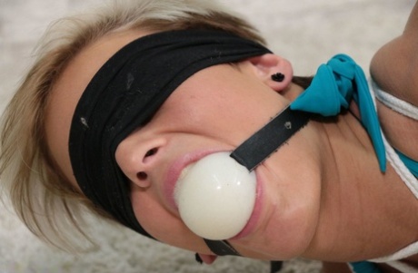 Short haired girl is ballgagged and hogtied in bare feet and a bikini