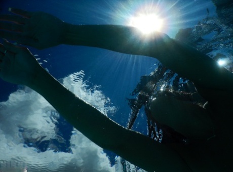 Authentic mom Nikki Sims playing with her covered up breasts in swimming pool