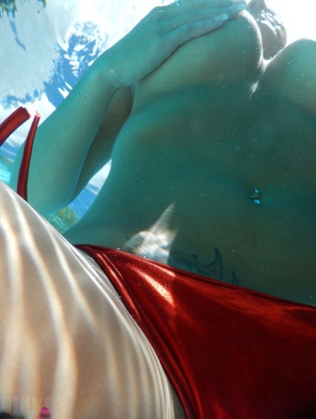 Authentic mom Nikki Sims playing with her covered up breasts in swimming pool