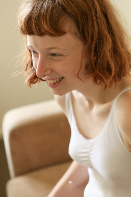 Pale redhead removes bodysuit to pet her hairy femininity in the artistic