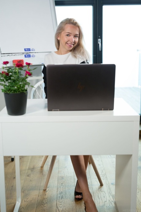Blonde young adult secretary Bernie removes her dress and poses artistic in the office