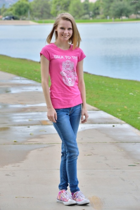 Sweet skinny young adult Catarina unveils her tiny breasts and tasty clam at the park