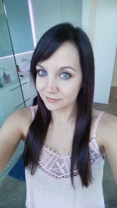 Slim young adult Andi Land takes candid artistic and clothed selfies while at home