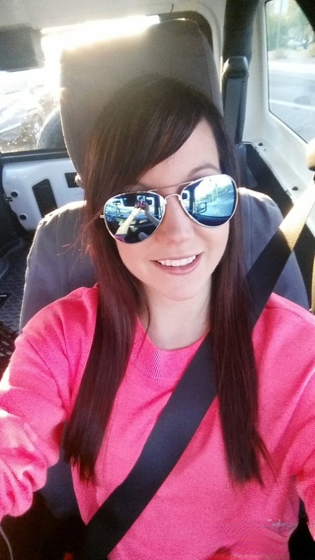 Slim young adult Andi Land takes candid artistic and clothed selfies while at home