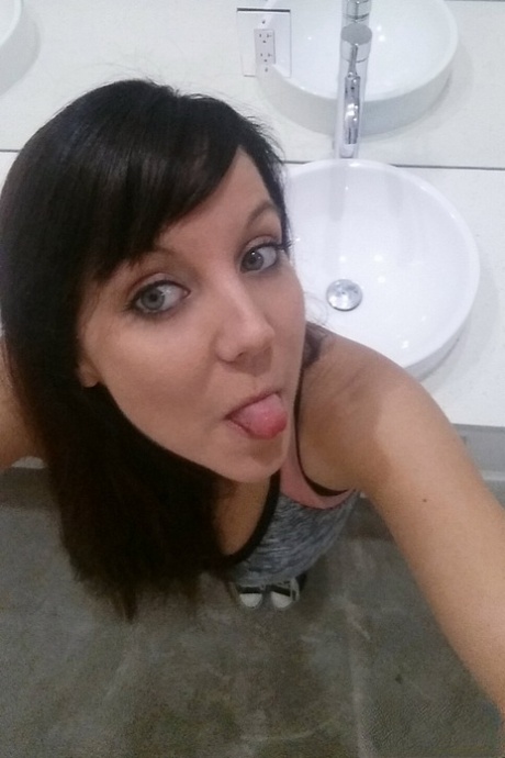 Slim young adult Andi Land takes candid artistic and clothed selfies while at home