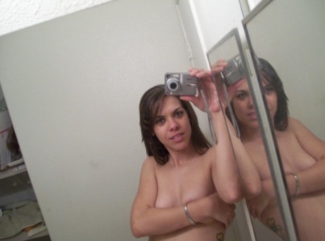 Authentic young adult shows off her fine curves in panties while taking artistic photos