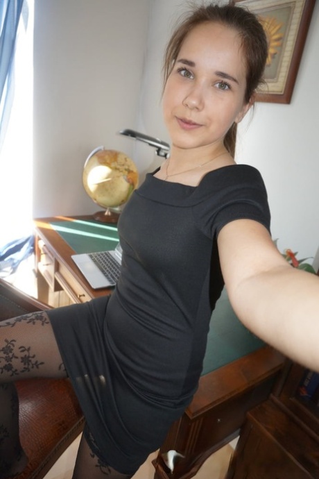 Beautiful authentic takes attractive artistic selfies while trying out her alluring outfits