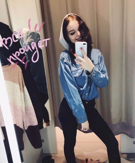Beautiful authentic takes attractive artistic selfies while trying out her alluring outfits
