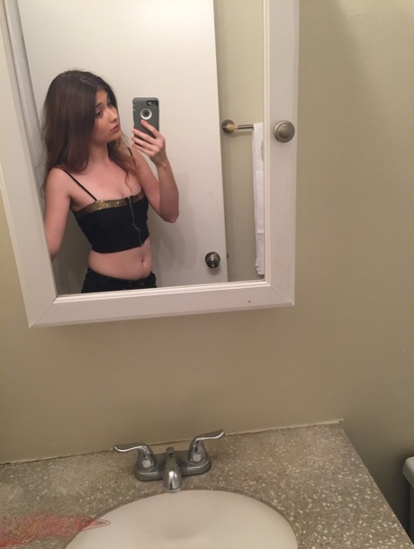 Petite young adult Ariel Mc Gwire makes her artistic modeling debut in bathroom selfies