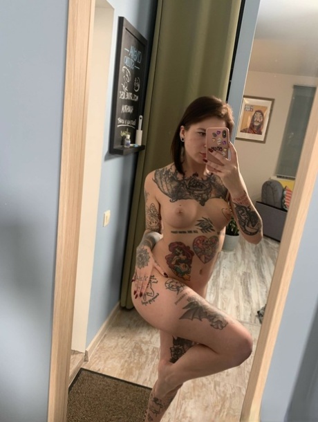 Tattooed babe shows off her small breasts & her big curves while taking artistic selfies