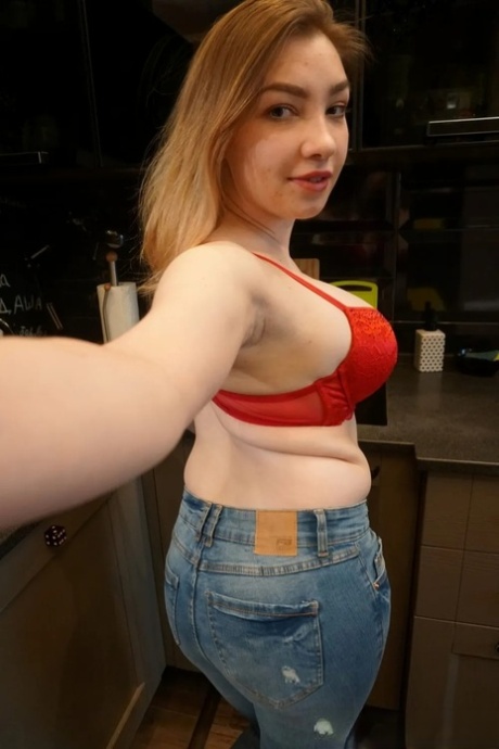 Dirty authentic babe holds her huge breasts and poses natural at her home