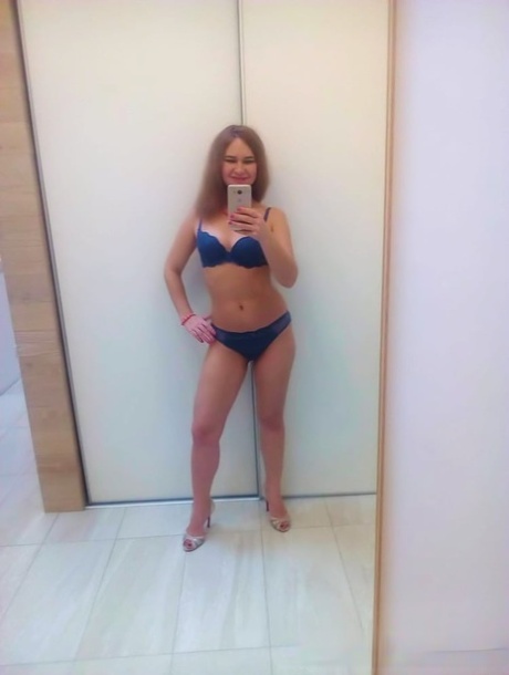 Authentic sweetheart takes selfies as she poses and strips in the mirror