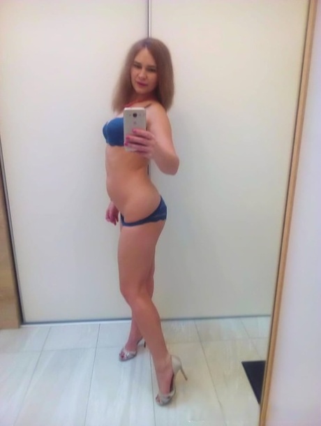 Authentic sweetheart takes selfies as she poses and strips in the mirror