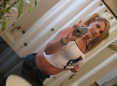 Blonde gf Hayden Night snaps selfies in bathroom while licking a lollipop