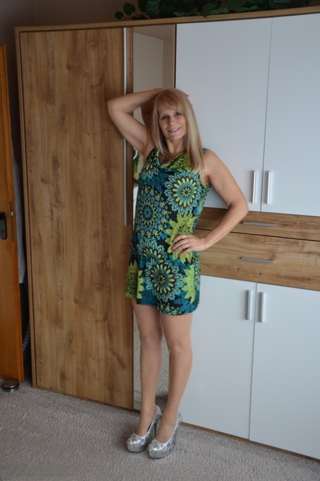 Middle-aged blonde Sweet Susi shows her tits and cunt both indoors and outside