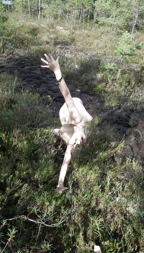 Outdoor posing with marvelous teen babe showing her ass in woods